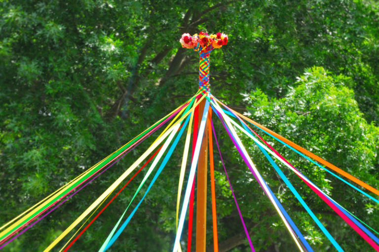 May pole wrapped with colorful ribbons.